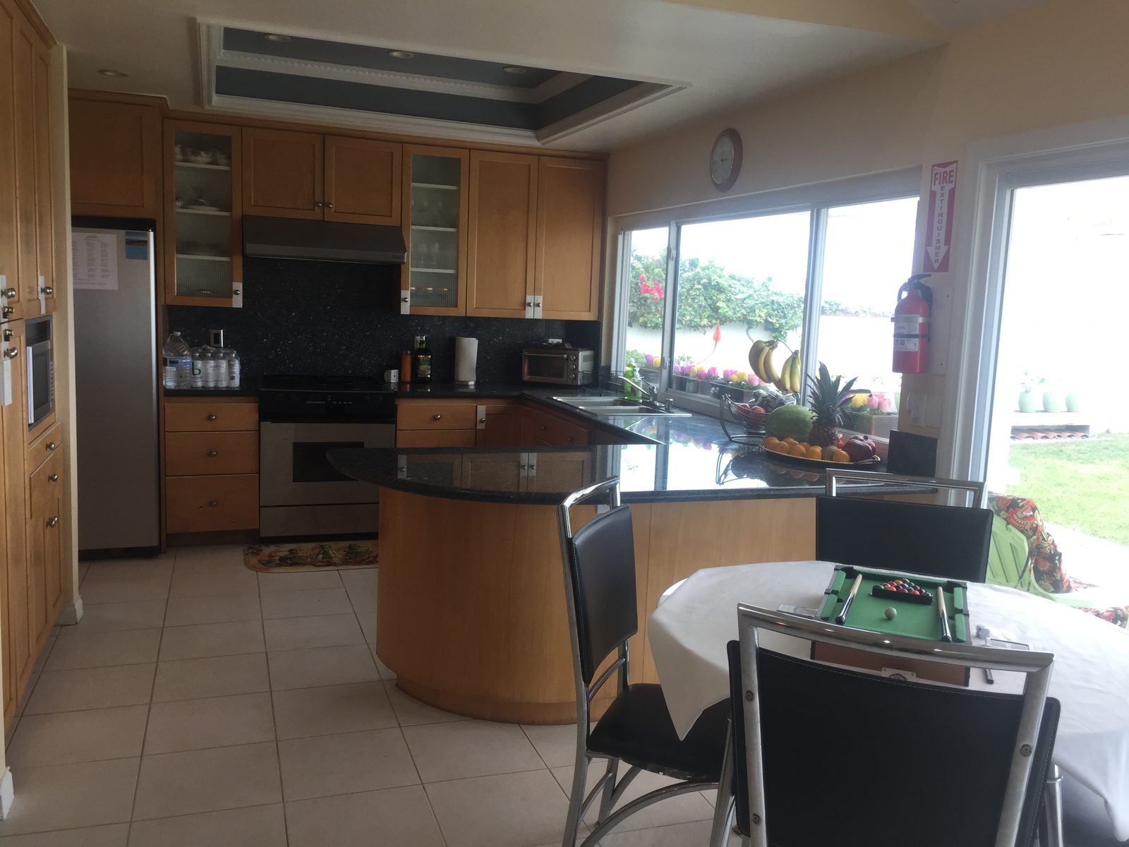 Bright kitchen with wood cabinets and a window overlooking the garden