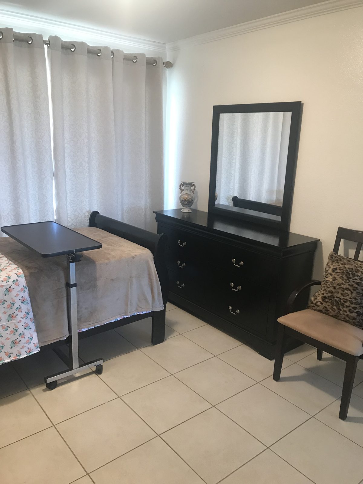 Private resident room with soft lighting and a tidy furnished layout
